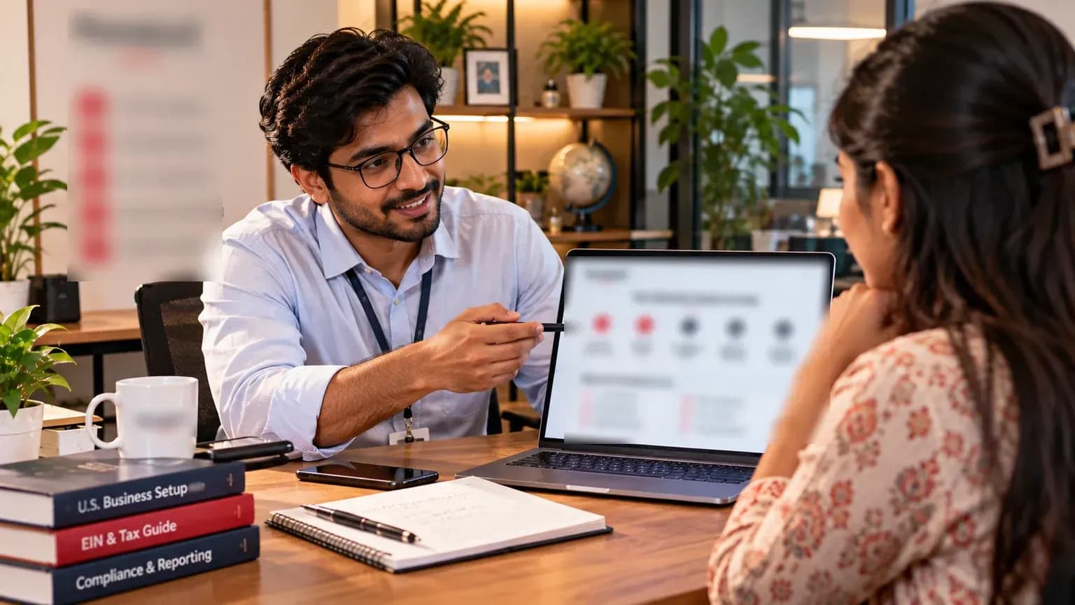 Advisor walking a client through business setup steps on a laptop