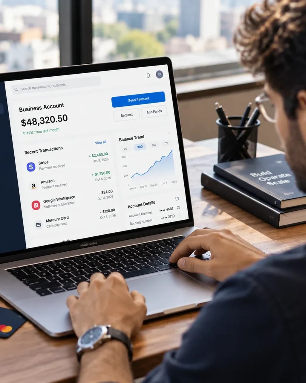 Founder checking a business bank account dashboard on a laptop